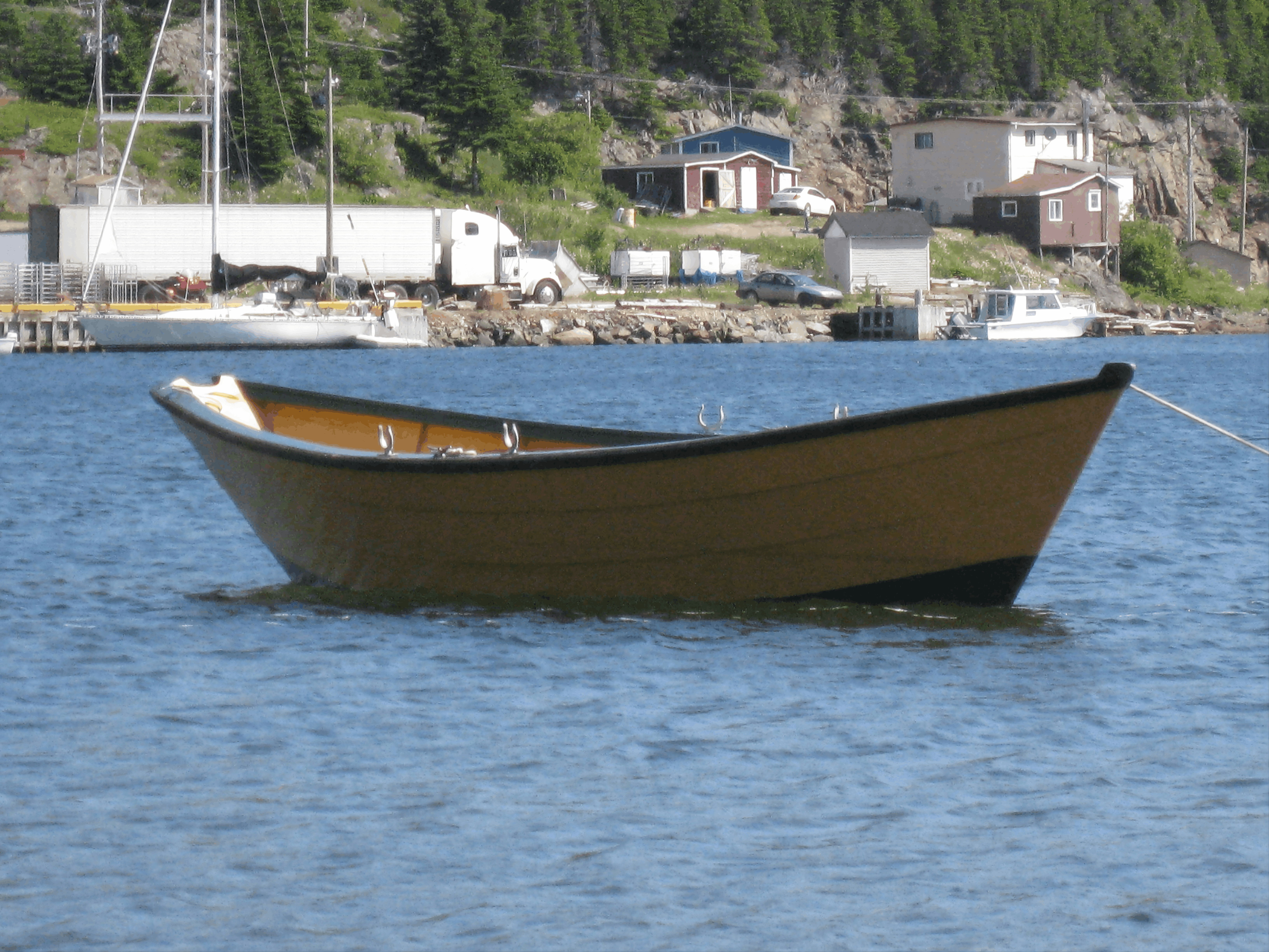Finished 16' Grand Banks dory on the water - the end result of a complete build